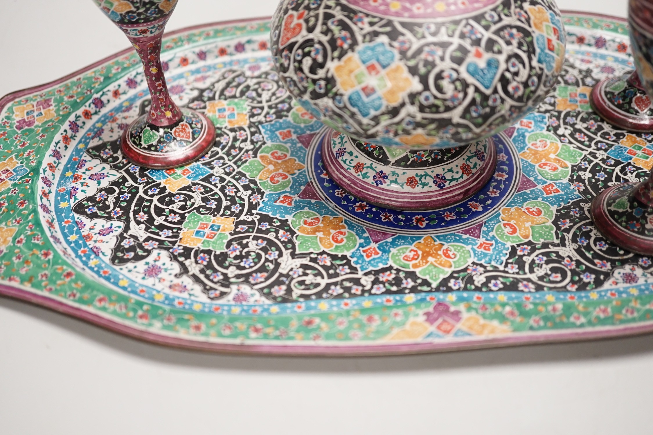 A decorative Persian enamel on copper set on stand. Tallest piece 20cm